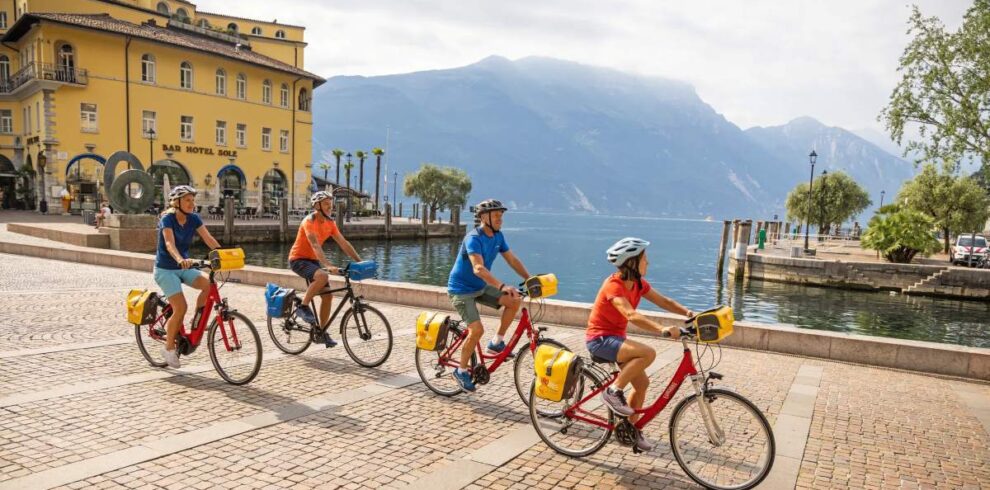 Group of people riding bikes by lake garda